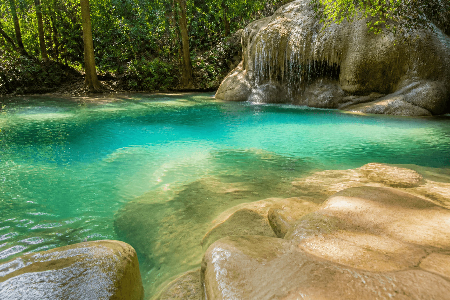 Emerald natural swimming pool at the base of Bua Tong waterfall